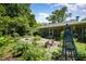 Expansive backyard featuring a pond, lounge chairs, screened in porch, and lush landscaping at 708 W Main St, Carrboro, NC 27510
