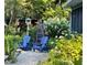 Secluded backyard sitting area features lounge chairs, a bird house, and lush hydrangeas at 708 W Main St, Carrboro, NC 27510