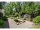 Lush backyard features a decorative pond, comfortable seating, and well-manicured landscaping at 708 W Main St, Carrboro, NC 27510