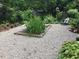A tranquil backyard featuring a small pond, lush greenery, and a comfortable chair at 708 W Main St, Carrboro, NC 27510