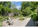 Idyllic backyard featuring a small pond, Adirondack chairs, and lush landscaping at 708 W Main St, Carrboro, NC 27510