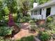 View of the front entrance, brick walkway, and front yard with garden at 708 W Main St, Carrboro, NC 27510