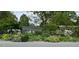 Charming single-story home surrounded by lush landscaping and mature trees for added privacy at 708 W Main St, Carrboro, NC 27510