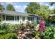 Charming one story home with a brick walkway and beautifully landscaped front yard at 708 W Main St, Carrboro, NC 27510