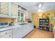 Bright kitchen with white cabinets, and a large window providing natural light at 708 W Main St, Carrboro, NC 27510