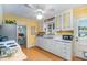 Kitchen with white cabinetry, stainless steel appliances and adjacent dining area at 708 W Main St, Carrboro, NC 27510