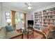 Inviting living room featuring a large bookcase, comfortable seating, and natural light at 708 W Main St, Carrboro, NC 27510