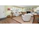 Light-filled living room featuring a fireplace, hardwood floors and neutral decor at 708 W Main St, Carrboro, NC 27510