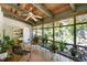 Cozy screened-in porch with wood ceiling, multiple seating areas, and backyard views at 708 W Main St, Carrboro, NC 27510