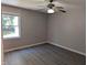 Bedroom featuring hardwood floors, a ceiling fan, and a window with natural light at 710 E Azalea Ct, Fuquay Varina, NC 27526