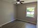 Cozy bedroom with hardwood floors and a window offering ample light overlooking a green lawn at 710 E Azalea Ct, Fuquay Varina, NC 27526