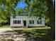 Charming single-story home featuring a white exterior, black shutters, and a well-maintained front yard at 710 E Azalea Ct, Fuquay Varina, NC 27526