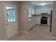 Functional kitchen with white cabinets, stainless steel appliances, and access to a back porch at 710 E Azalea Ct, Fuquay Varina, NC 27526
