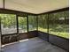 Inviting screened-in porch with ample space for outdoor seating, overlooking the backyard at 710 E Azalea Ct, Fuquay Varina, NC 27526