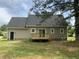 The backyard features a wooden deck and mature trees, offering a private outdoor space at 717 Papsworth Ct, Fuquay Varina, NC 27526