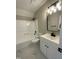 Bathroom with white vanity, black fixtures, and tiled shower-tub at 717 Papsworth Ct, Fuquay Varina, NC 27526