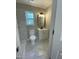 Renovated bathroom with white vanity, framed mirror, and tiled floors at 717 Papsworth Ct, Fuquay Varina, NC 27526