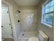Tiled shower with modern black fixtures and bright window for natural light at 717 Papsworth Ct, Fuquay Varina, NC 27526