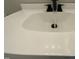 Close-up of a white bathroom sink with sleek black faucet at 717 Papsworth Ct, Fuquay Varina, NC 27526