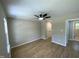 Large bedroom featuring wood flooring, a ceiling fan, and neutral colored walls at 717 Papsworth Ct, Fuquay Varina, NC 27526