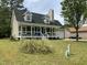Inviting two-story home featuring a cozy front porch and an attached garage at 717 Papsworth Ct, Fuquay Varina, NC 27526