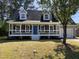 Charming two-story home with a covered front porch and a vibrant blue front door at 717 Papsworth Ct, Fuquay Varina, NC 27526