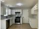 Bright kitchen boasts modern stainless steel appliances and white cabinetry at 717 Papsworth Ct, Fuquay Varina, NC 27526