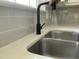 Modern stainless steel kitchen sink with quartz countertop and faucet at 717 Papsworth Ct, Fuquay Varina, NC 27526