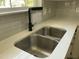 Stainless kitchen sink with quartz countertop and modern faucet at 717 Papsworth Ct, Fuquay Varina, NC 27526