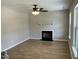 Bright living room featuring wood floors, a fireplace, and a ceiling fan at 717 Papsworth Ct, Fuquay Varina, NC 27526