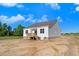Rear view of the home showcasing the wooden deck, windows, and white siding at 72 Glenwood Pl, Kenly, NC 27542
