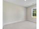 Neutral bedroom featuring plush carpeting and a large window with natural light at 72 Glenwood Pl, Kenly, NC 27542