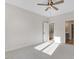 Bright bedroom with neutral carpet and ceiling fan plus adjoining bath and closet at 72 Glenwood Pl, Kenly, NC 27542
