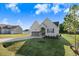 Charming two-story home with gray garage door, manicured lawn, and newly planted tree at 72 Glenwood Pl, Kenly, NC 27542