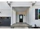 View of the home's entry way, showing a sleek black door with glass and modern design elements at 72 Glenwood Pl, Kenly, NC 27542
