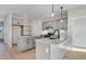 Bright kitchen featuring grey cabinets, marble countertops, a kitchen island, and stainless steel appliances at 72 Glenwood Pl, Kenly, NC 27542
