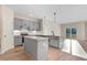 A kitchen featuring grey cabinets, marble countertops, a kitchen island, and stainless steel appliances at 72 Glenwood Pl, Kenly, NC 27542