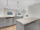 A kitchen featuring grey cabinets, marble countertops, stainless steel appliances, and access to the outdoor deck at 72 Glenwood Pl, Kenly, NC 27542