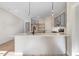 An open kitchen with white cabinets, marble countertops, and stainless steel appliances provides style and function at 72 Glenwood Pl, Kenly, NC 27542
