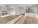 Open concept living room featuring fireplace, ceiling fan, and view into the kitchen at 72 Glenwood Pl, Kenly, NC 27542