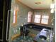 Well-lit bathroom boasts dual sinks, a soaking tub, and ample natural light from the window at 80 White Deer Ln, Henderson, NC 27537