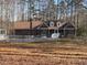 Charming single-story brick home with a well-maintained lawn and surrounding woods at 80 White Deer Ln, Henderson, NC 27537