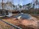 Backyard swimming pool with an adjacent deck and covered pavilion, set against a backdrop of mature trees at 80 White Deer Ln, Henderson, NC 27537
