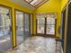 Bright and airy sunroom featuring tile flooring, a skylight, and walls of windows offering scenic views at 80 White Deer Ln, Henderson, NC 27537