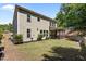 Spacious backyard featuring a lush lawn, mature landscaping, and a screened-in porch at 8840 Forester Ln, Apex, NC 27539