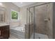 A well-appointed bathroom with a combination tub and shower, and a window providing natural light at 8840 Forester Ln, Apex, NC 27539