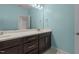 Stylish bathroom showcasing a double vanity with marble countertops and blue walls at 8840 Forester Ln, Apex, NC 27539