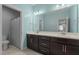 Well-lit bathroom featuring a double vanity, tile flooring, and a shower-tub combination at 8840 Forester Ln, Apex, NC 27539