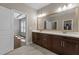 A Primary bathroom featuring double sinks, a large vanity, and a doorway leading to another room at 8840 Forester Ln, Apex, NC 27539