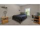 Comfortable bedroom with a dark metal bed frame, a desk area, and a window for natural light at 8840 Forester Ln, Apex, NC 27539